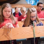 students praying the rosary